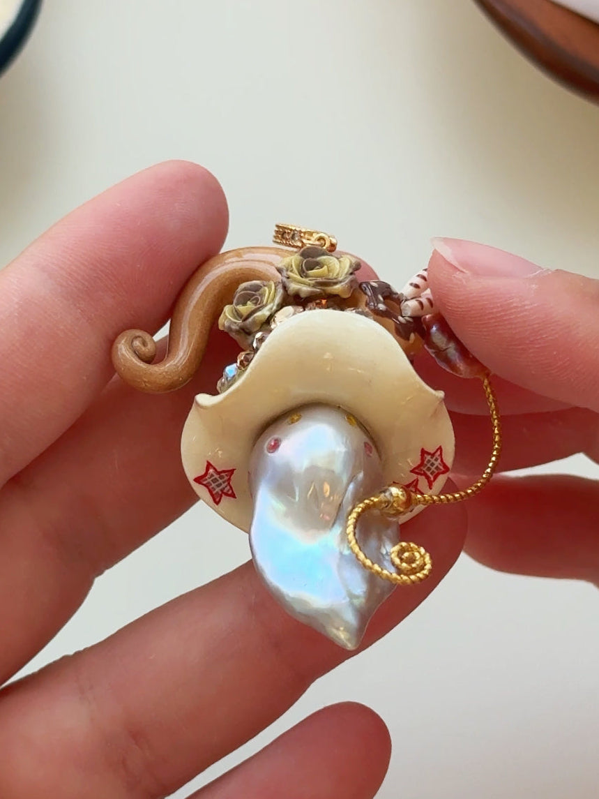 [PIECE04] Donut Dream Sprite baroque pearl necklace with donut-inspired hat, sculpted frosted donut, pastel roses, sparkling stones, playful dessert details, and natural baroque pearl