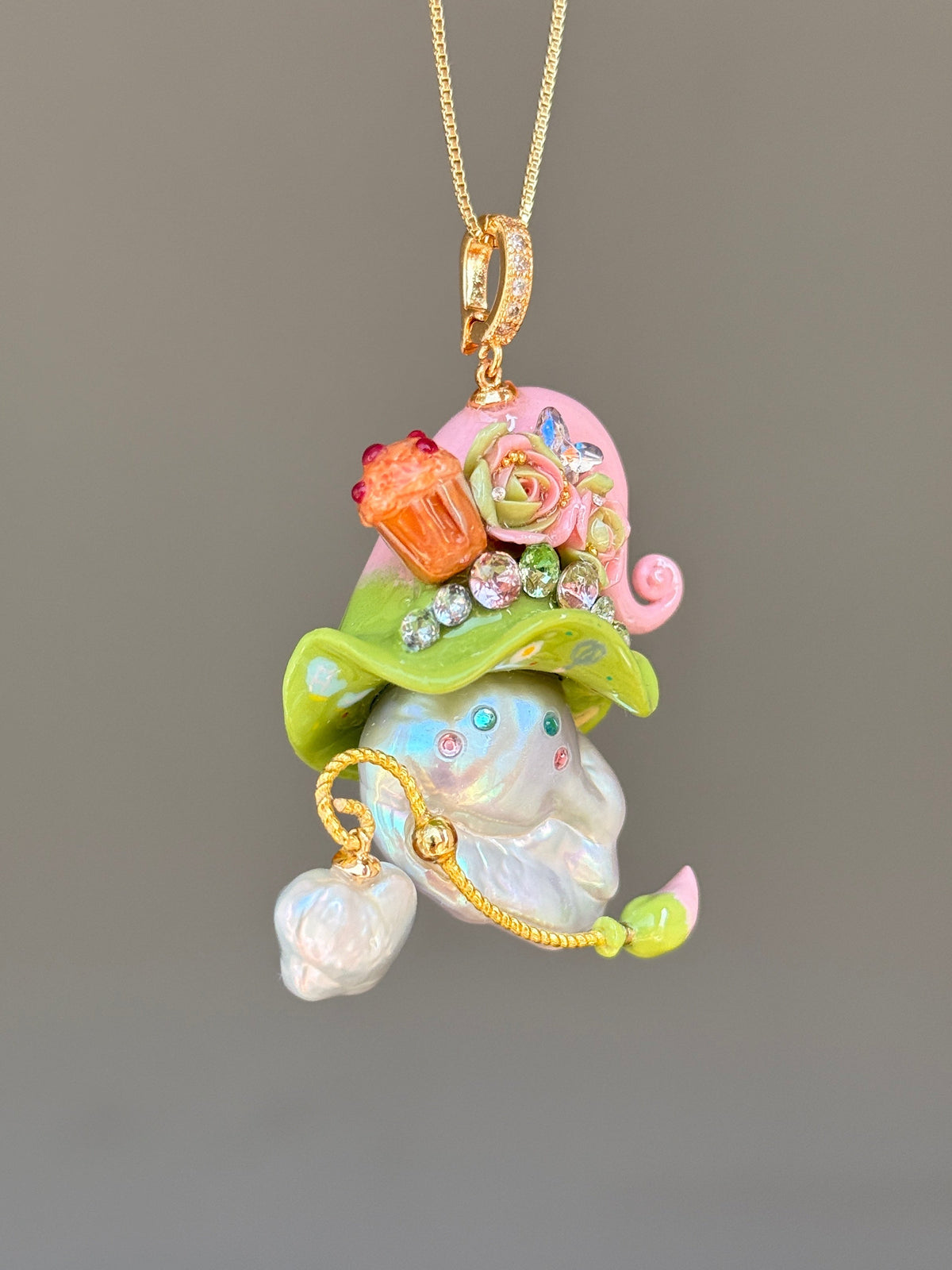 [PIECE01] Muffin Sprite baroque pearl necklace with pastel blue hat, soft yellow curl, sculpted orange muffin detail, mint floral accents, sparkling crystals, gold wand, and natural baroque pearl