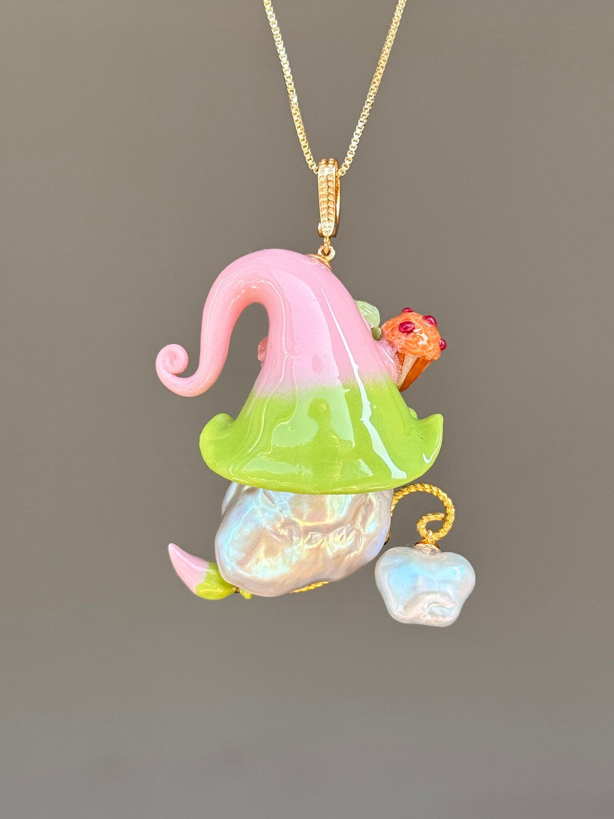 [PIECE01] Muffin Sprite baroque pearl necklace with pastel blue hat, soft yellow curl, sculpted orange muffin detail, mint floral accents, sparkling crystals, gold wand, and natural baroque pearl