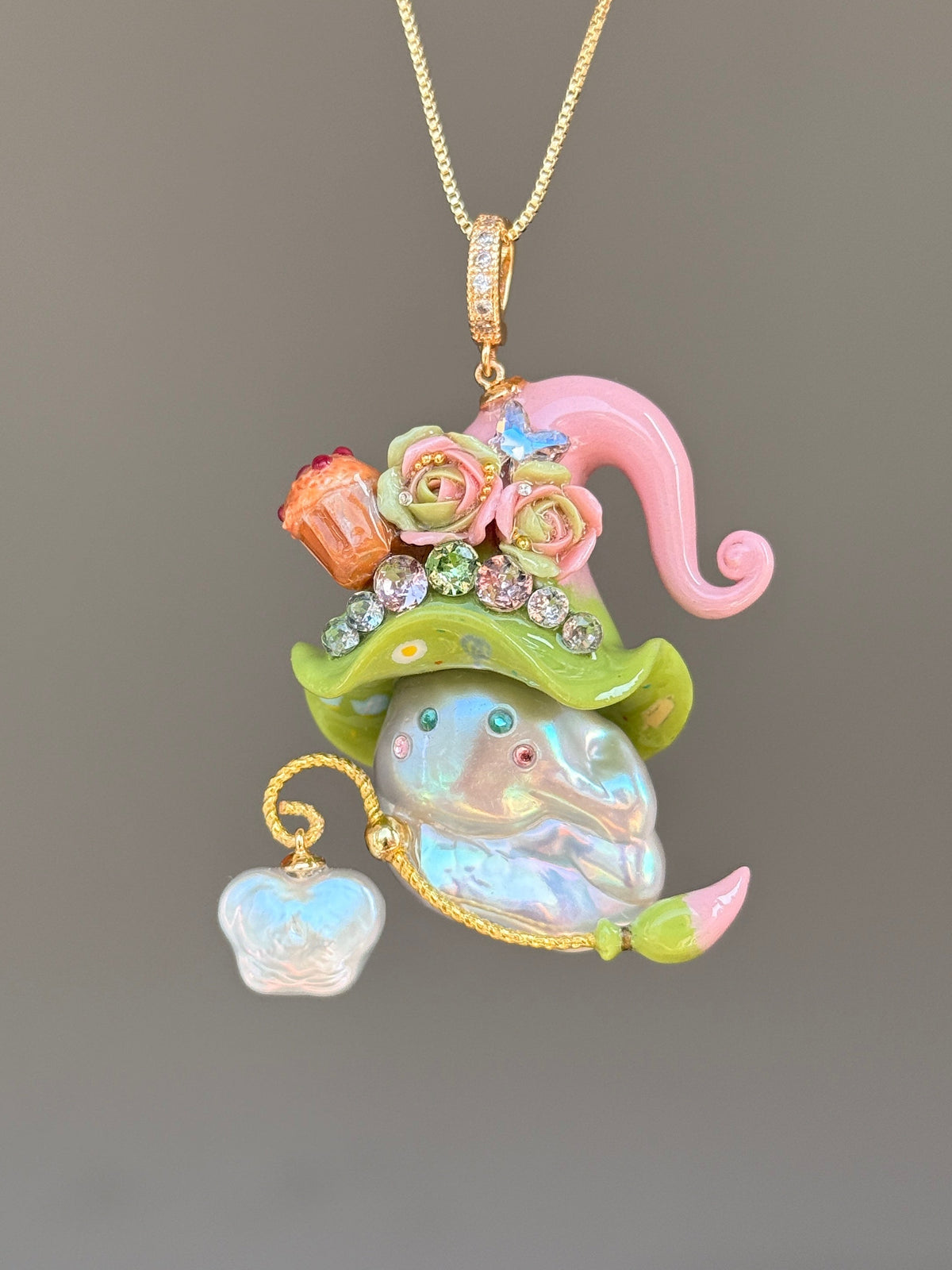 [PIECE01] Muffin Sprite baroque pearl necklace with pastel blue hat, soft yellow curl, sculpted orange muffin detail, mint floral accents, sparkling crystals, gold wand, and natural baroque pearl
