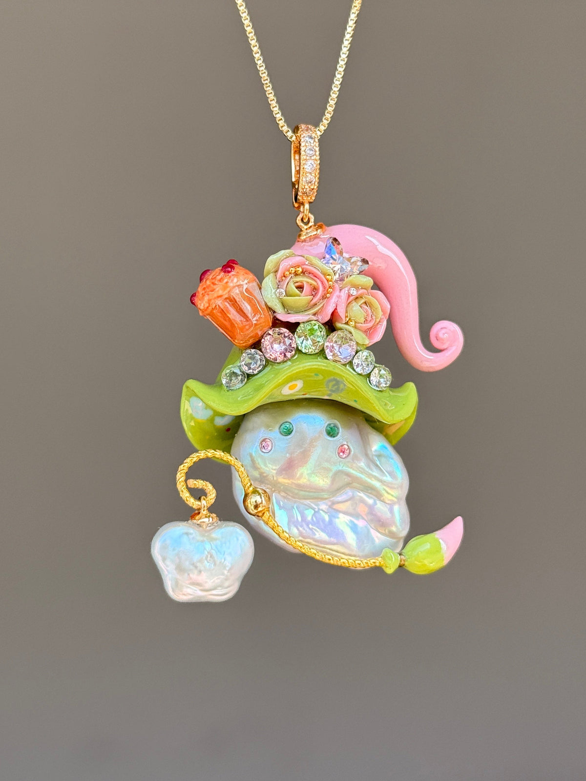 [PIECE01] Muffin Sprite baroque pearl necklace with pastel blue hat, soft yellow curl, sculpted orange muffin detail, mint floral accents, sparkling crystals, gold wand, and natural baroque pearl