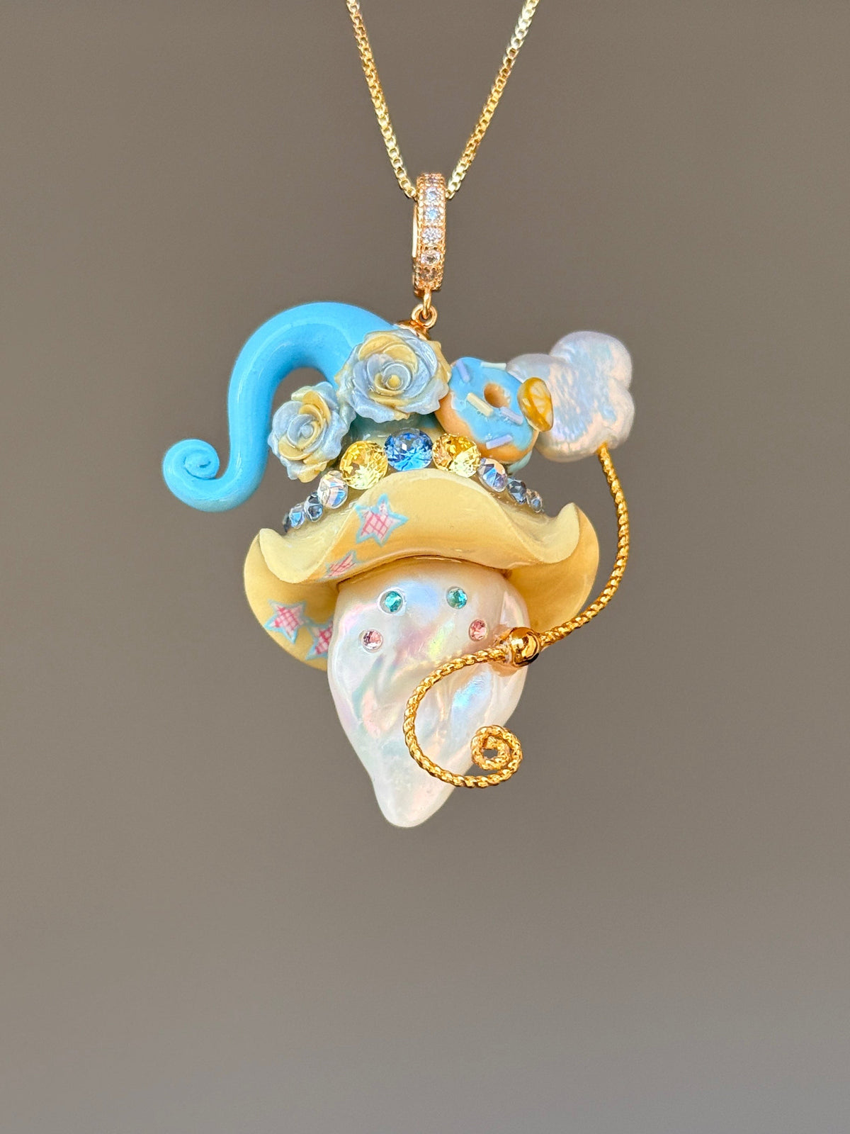 [PIECE02] Donut Dream Sprite baroque pearl necklace with donut-inspired hat, sculpted frosted donut, pastel floral accents, sparkling stones, whimsical candy-colored details, and natural baroque pearl