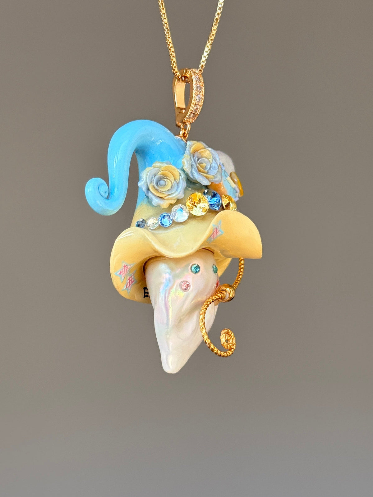 [PIECE02] Donut Dream Sprite baroque pearl necklace with donut-inspired hat, sculpted frosted donut, pastel floral accents, sparkling stones, whimsical candy-colored details, and natural baroque pearl