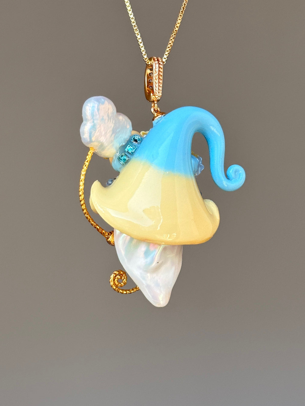 [PIECE02] Donut Dream Sprite baroque pearl necklace with donut-inspired hat, sculpted frosted donut, pastel floral accents, sparkling stones, whimsical candy-colored details, and natural baroque pearl