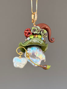 [PIECE07] Bakery Sprite baroque pearl necklace with olive green pretzel-inspired hat, sculpted pretzel detail, floral accents, gold wand, and natural baroque pearl