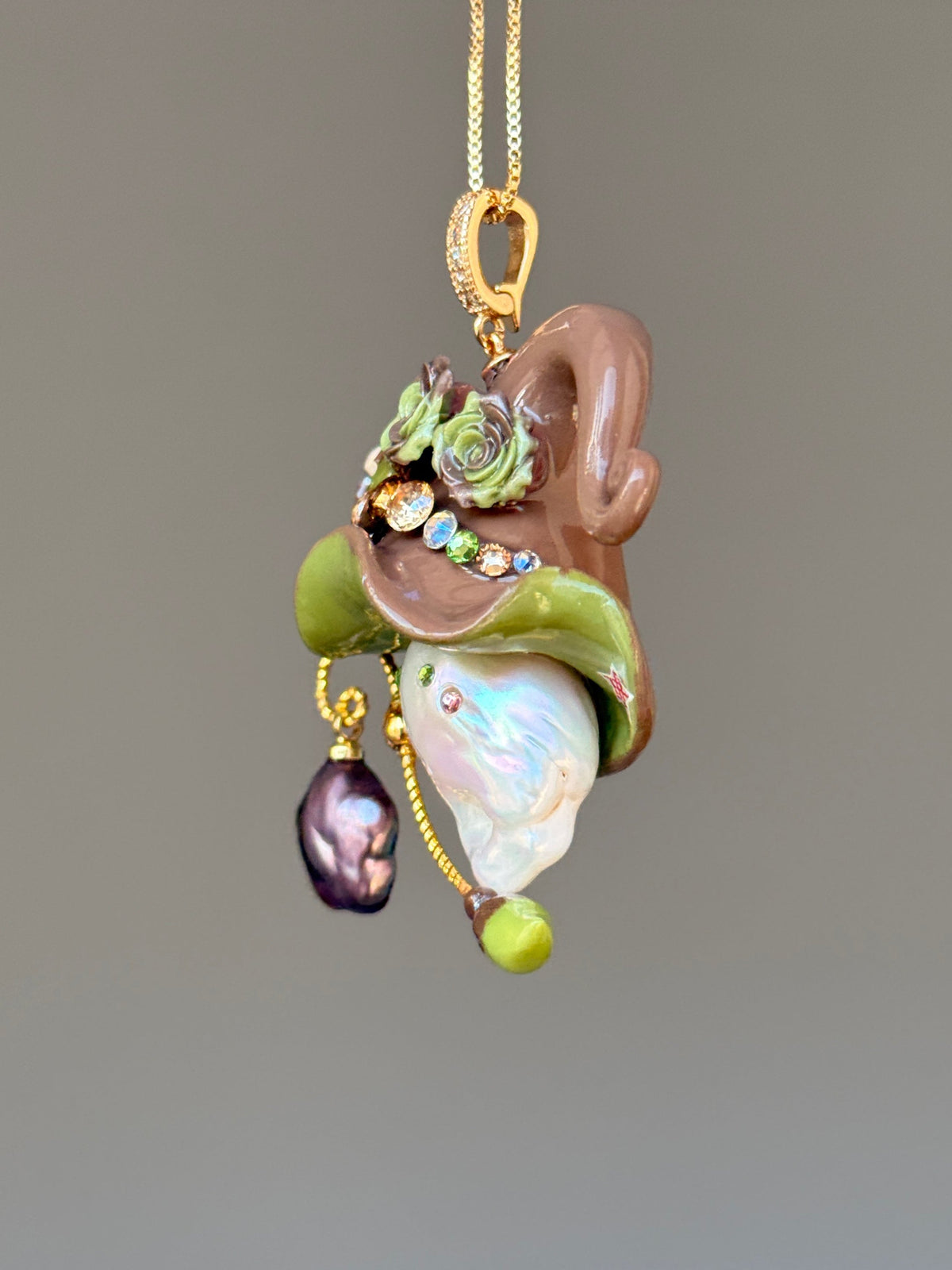 [PIECE01] Donut Dream Sprite baroque pearl necklace with yellow donut-inspired hat, sculpted pink frosted donut, pastel roses, sparkling stones, star details, pink curled accent, pearl charm, paintbrush detail, and natural baroque pearl