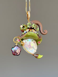 [PIECE01] Donut Dream Sprite baroque pearl necklace with yellow donut-inspired hat, sculpted pink frosted donut, pastel roses, sparkling stones, star details, pink curled accent, pearl charm, paintbrush detail, and natural baroque pearl