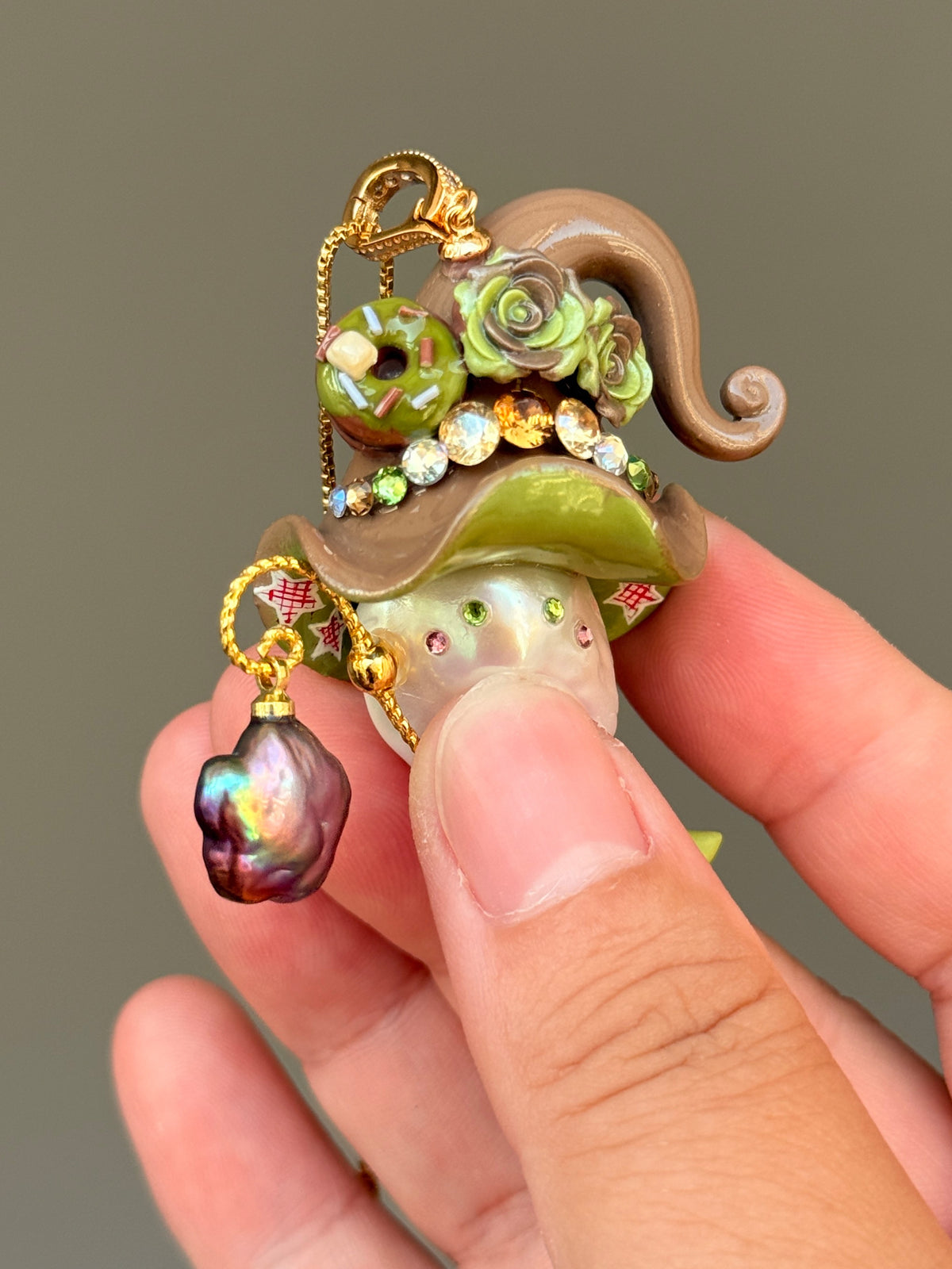 [PIECE01] Donut Dream Sprite baroque pearl necklace with yellow donut-inspired hat, sculpted pink frosted donut, pastel roses, sparkling stones, star details, pink curled accent, pearl charm, paintbrush detail, and natural baroque pearl