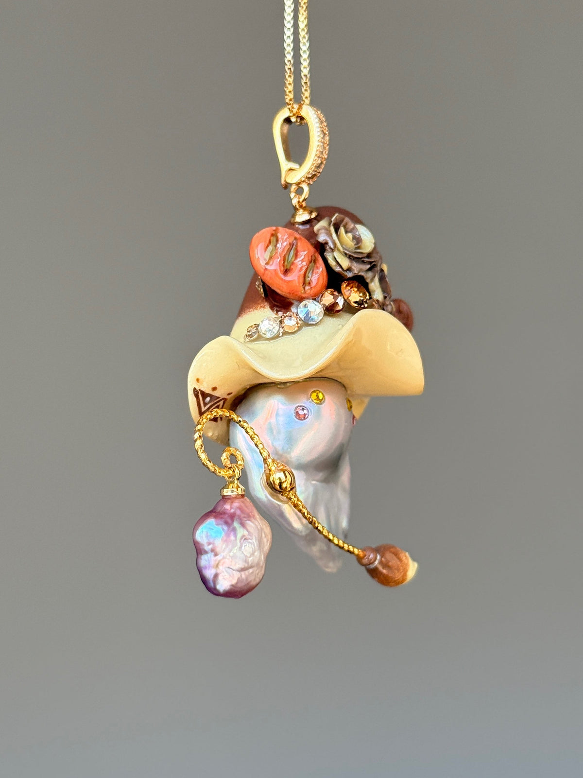 [PIECE08] Bakery Sprite baroque pearl necklace with artisan roll-inspired hat, sculpted bread detail, floral accents, gold wand, and natural baroque pearl