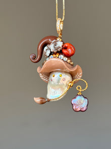 [PIECE09] Bakery Sprite baroque pearl necklace with taupe bagel-inspired hat, sculpted bagel detail, floral accents, gold wand, and natural baroque pearl