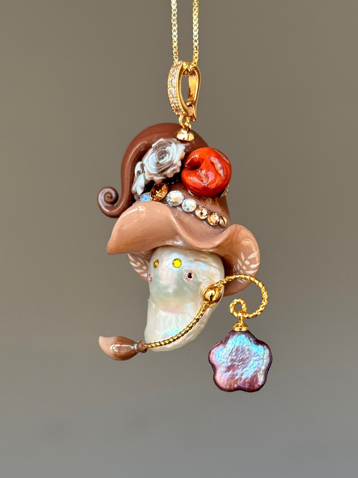 [PIECE09] Bakery Sprite baroque pearl necklace with taupe bagel-inspired hat, sculpted bagel detail, floral accents, gold wand, and natural baroque pearl