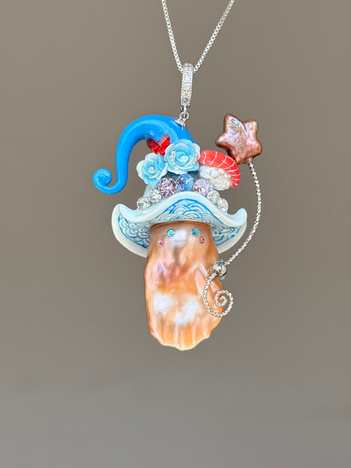 [PIECE01] Sushi Sprite baroque pearl necklace with sushi-inspired hat, sculpted sushi detail, blue floral accents, sparkling stones, dangling charm, and natural baroque pearl