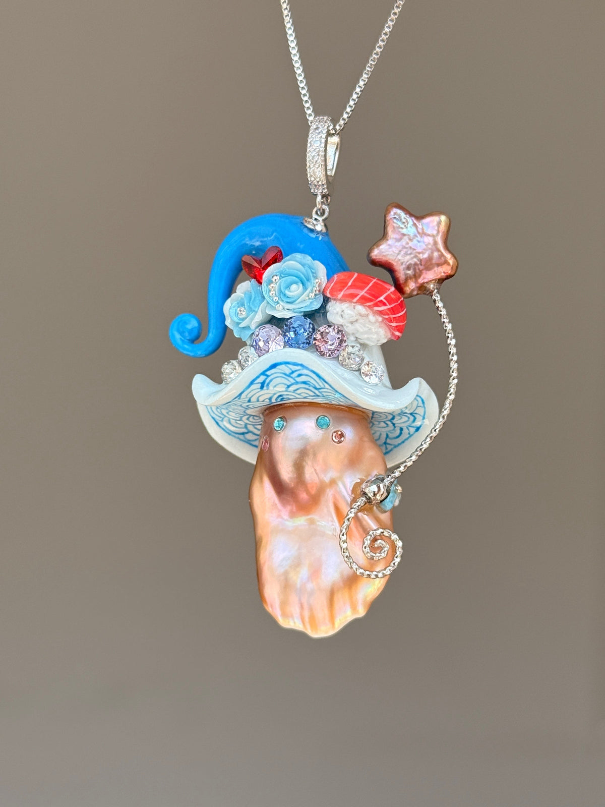 [PIECE01] Sushi Sprite baroque pearl necklace with sushi-inspired hat, sculpted sushi detail, blue floral accents, sparkling stones, dangling charm, and natural baroque pearl