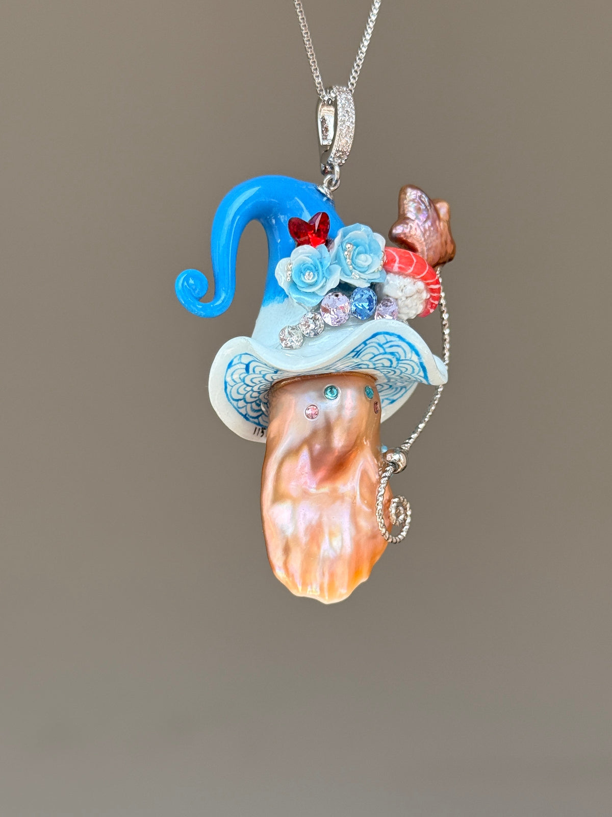 [PIECE01] Sushi Sprite baroque pearl necklace with sushi-inspired hat, sculpted sushi detail, blue floral accents, sparkling stones, dangling charm, and natural baroque pearl