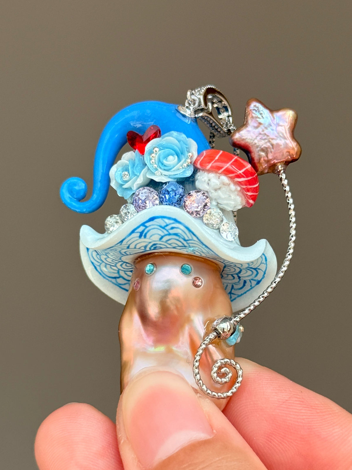 [PIECE01] Sushi Sprite baroque pearl necklace with sushi-inspired hat, sculpted sushi detail, blue floral accents, sparkling stones, dangling charm, and natural baroque pearl