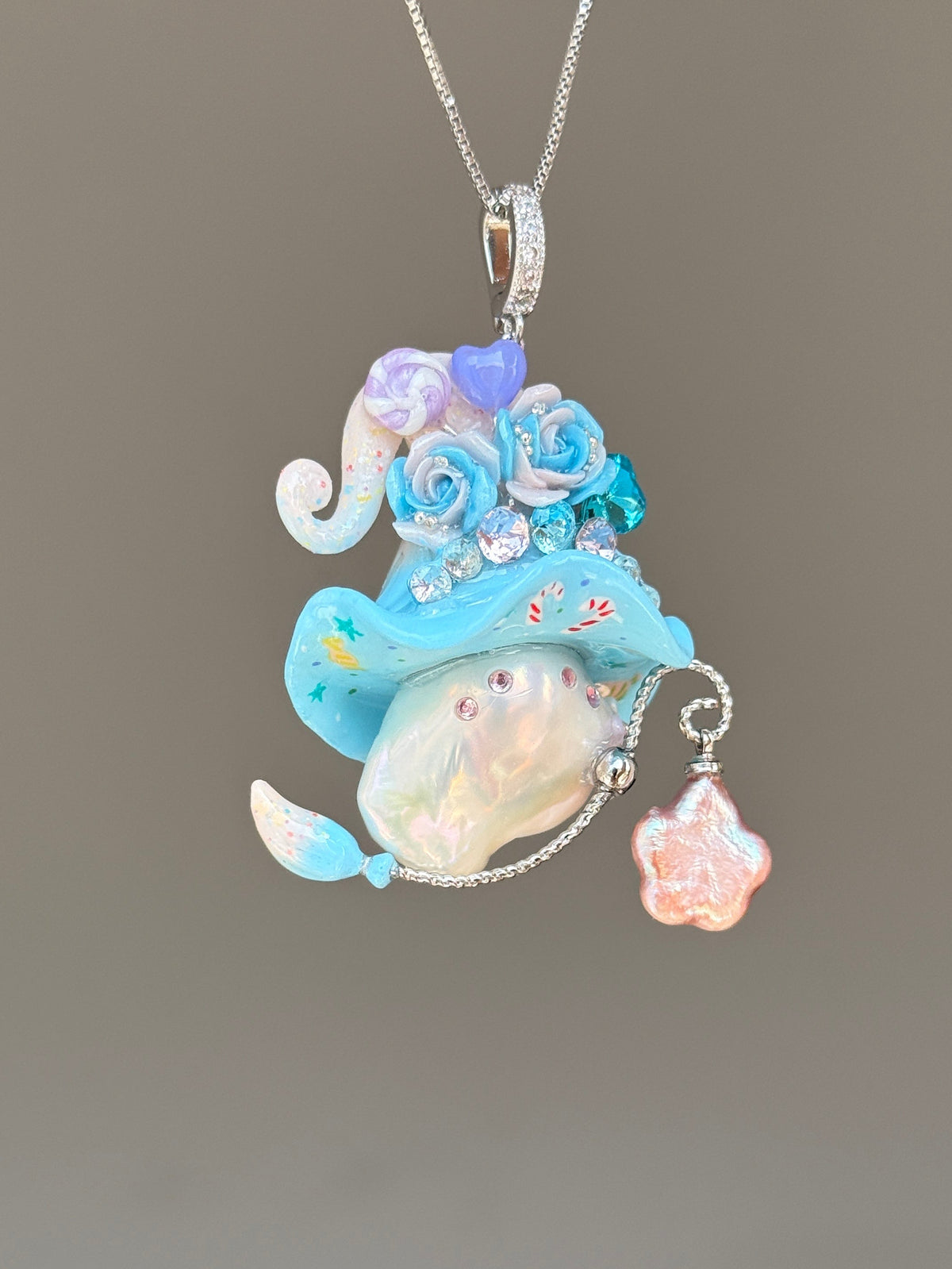 [PIECE03] Lollipop Sprite baroque pearl necklace with a curled mini hat, sculpted candy details, floral accents, sparkling crystals, a dangling charm, and natural baroque pearl