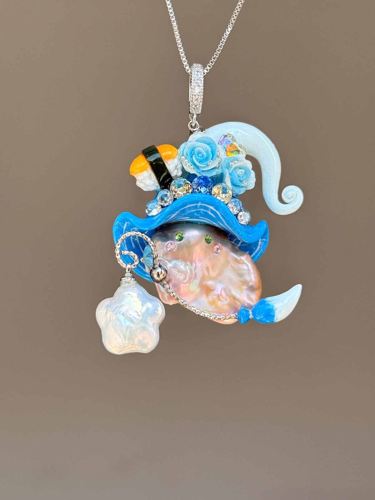 [PIECE02] Sushi Sprite baroque pearl necklace with sushi-inspired hat, sculpted sushi detail, blue floral accents, sparkling stones, dangling charm, and natural baroque pearl