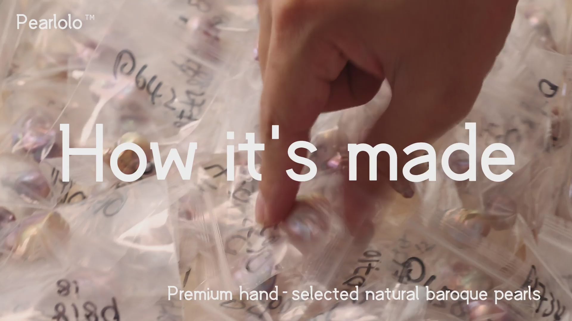 Load video: Pearlolo handmade process: selecting a natural baroque pearl, hand-sculpting a resin mini hat, drilling and setting metal findings, then gift-packaging the finished pieces.